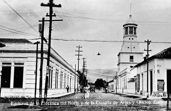 Calle 13 Avenida 4a. Década del 30. A la izquierda La Escuela de Artes y Oficios hoy Colegio Femenino Normal Maria Auxiliadoray a la derecha La Torre del Reloj o Edificio de la Compañía Eléctrica del Norte.