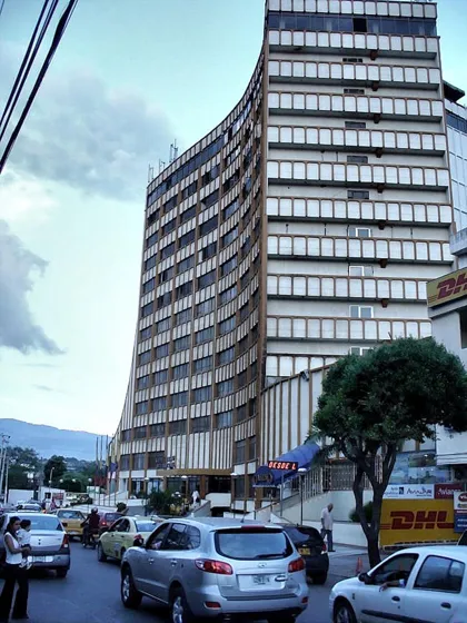 Edificio alto de oficinas sobre una avenida congestionada